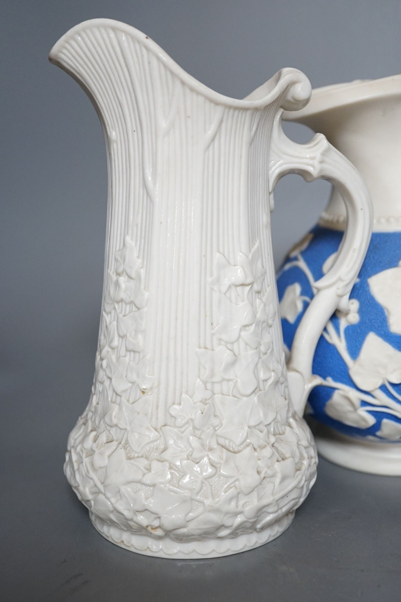 A Samuel Alcock relief-moulded jug, 20cm, and two other jugs